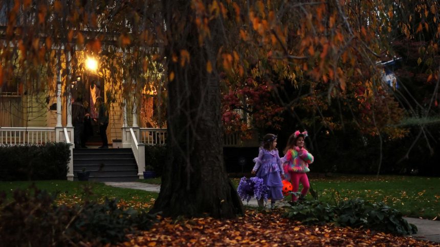 Children go trick-or-treating in the New York suburb of Upper Nyack, New York, on October 31, 2023.