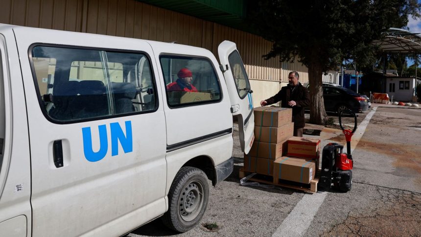 UNRWA workers transport boxes of humanitarian aid at the West Bank field office complex of UNRWA, in the Sheikh Jarrah neighborhood of East Jerusalem, on January 30, 2024.