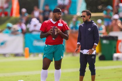 Jul 28, 2024; Miami Gardens, FL, USA; Miami Dolphins quarterback Tua Tagovailoa (1) talks to head coach Mike McDaniel during training camp at Baptist Health Training Complex. Mandatory Credit: Sam Navarro-USA TODAY Sports