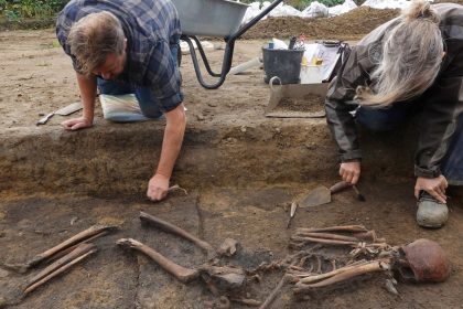 Archaeologists excavate skeletons in a pit at the Viking-age burial site in the village of Asum, Denmark, September 25, 2024. REUTERS/Tom Little