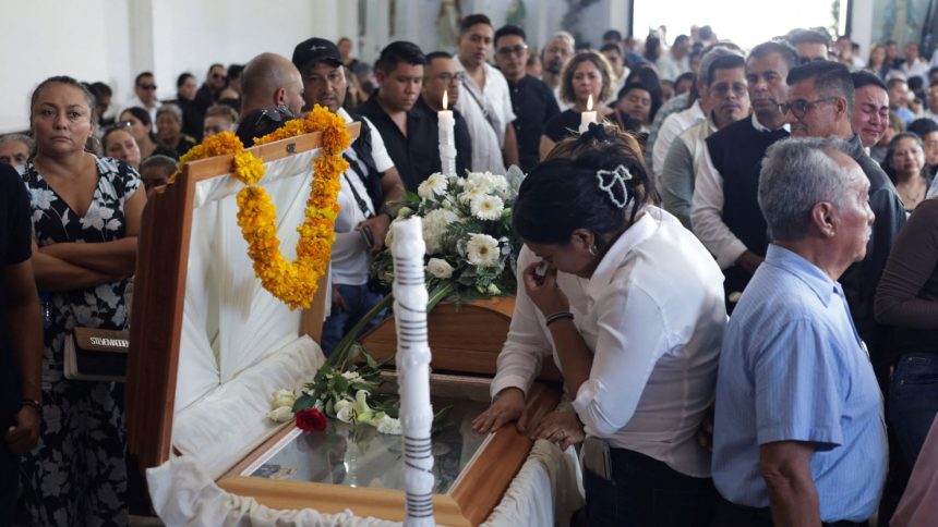 Mourners pay their respects at the casket of Alejandro Arcos, the mayor of Chilpancingo who was killed on Sunday less than a week after taking office.