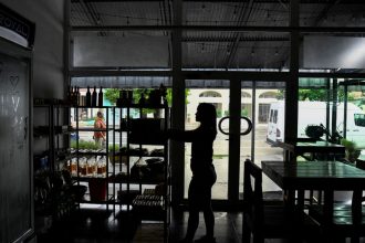 A woman works in a restaurant during a blackout in Havana, Cuba, on Thursday.