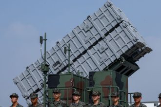 Members of the Taiwanese Navy Hai Feng (Sea Blade) Group stand in front of Hsiung Feng III mobile missile launcher during Taiwanese President Lai Ching-te’s visit to the base in response to recent Chinese military drills, in Taoyuan, Taiwan October 18, 2024.