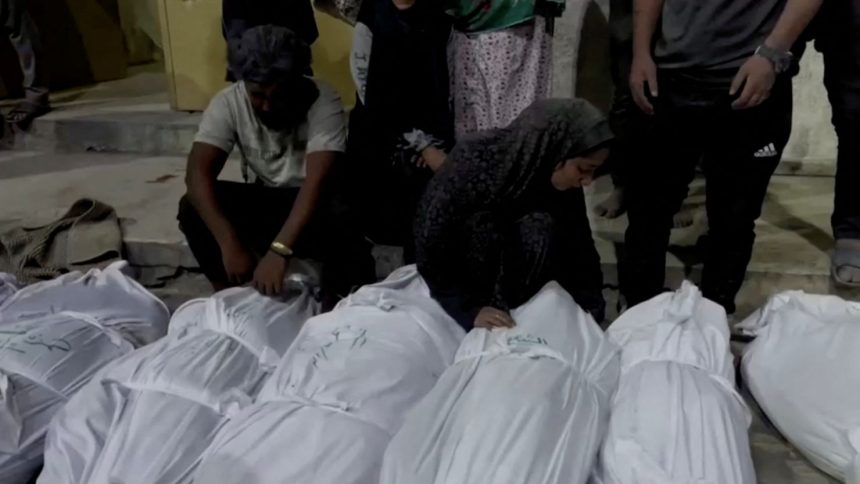 Mourners react next to the bodies of Palestinians killed in Israeli strikes at Kamal Adwan hospital in Jabalia, in the northern Gaza Strip in this still image taken from a video on Sunday.