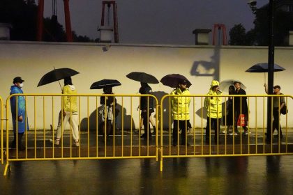 Police officers keep watch near barricades set up along Julu Road where people in Halloween costumes gathered the year before, in Shanghai, China October 26, 2024.