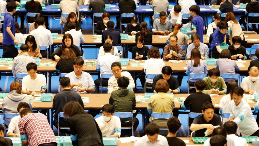 Election officers count ballots for the general election at a ballot counting centre in Tokyo on Sunday.