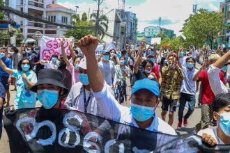 Anti-coup protesters march during a demonstration against the Myanmar junta's internet restrictions in Yangon on May 12, 2021.