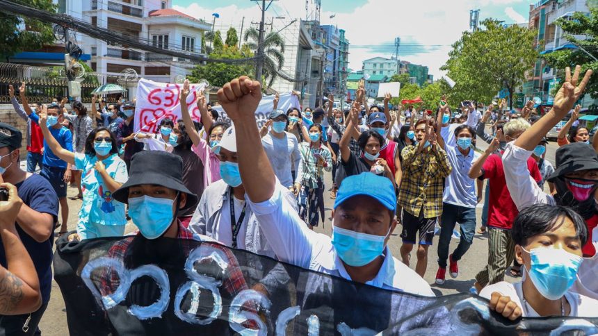 Anti-coup protesters march during a demonstration against the Myanmar junta's internet restrictions in Yangon on May 12, 2021.