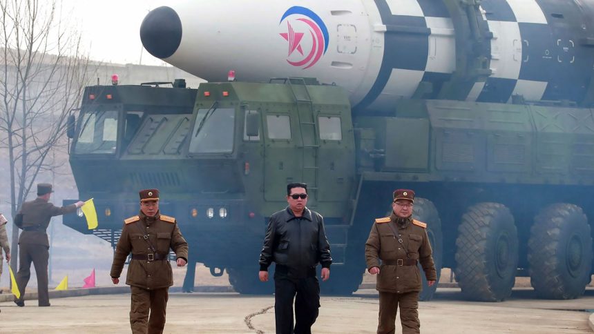 In this photo distributed by the North Korean government, North Korean leader Kim Jong Un walks around what it says is a Hwasong-17 intercontinental ballistic missile (ICBM) on the launcher, at an undisclosed location in North Korea on March 24, 2022.