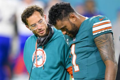 Miami Dolphins quarterback Tua Tagovailoa (right) walks off the field with head coach Mike McDaniel during the game against the Buffalo Bills.