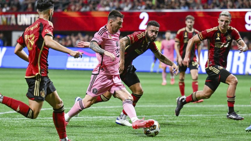 Lionel Messi takes on the Atlanta United defense during an MLS match at Mercedes-Benz Stadium.