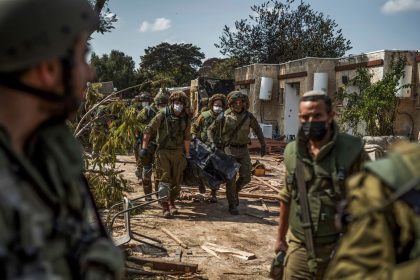 Israeli forces recover bodies of killed Israeli residents from a destroyed house in Kibbutz Kfar Aza, amid the fighting between Israel and the Palestinian militant group Hamas, on October 10, 2023.