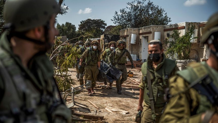 Israeli forces recover bodies of killed Israeli residents from a destroyed house in Kibbutz Kfar Aza, amid the fighting between Israel and the Palestinian militant group Hamas, on October 10, 2023.