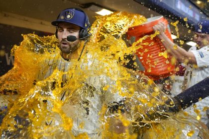 The Milwaukee Brewers' Garrett Mitchell is doused by Willy Adames after Milwaukee tied the series against the New York Mets.