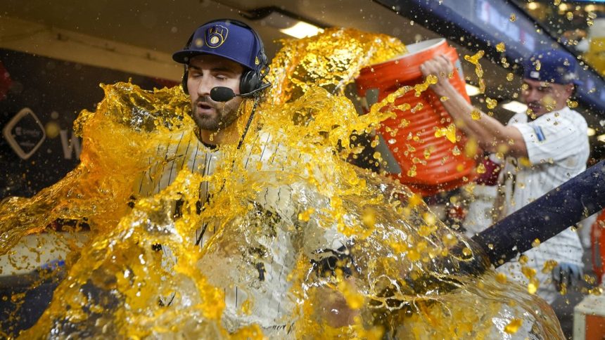 The Milwaukee Brewers' Garrett Mitchell is doused by Willy Adames after Milwaukee tied the series against the New York Mets.