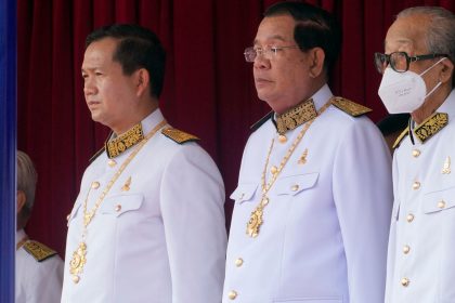 Cambodian Prime Minister Hun Manet (left) stands next to his father and former prime minister Hun Sen (center), during the country's 70th Independence Day, in Phnom Penh, Cambodia, on Thursday, Nov. 9, 2023.