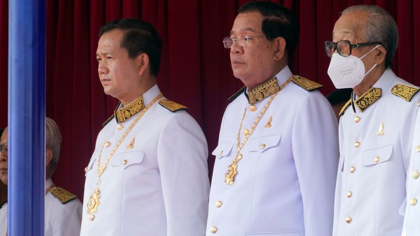 Cambodian Prime Minister Hun Manet (left) stands next to his father and former prime minister Hun Sen (center), during the country's 70th Independence Day, in Phnom Penh, Cambodia, on Thursday, Nov. 9, 2023.