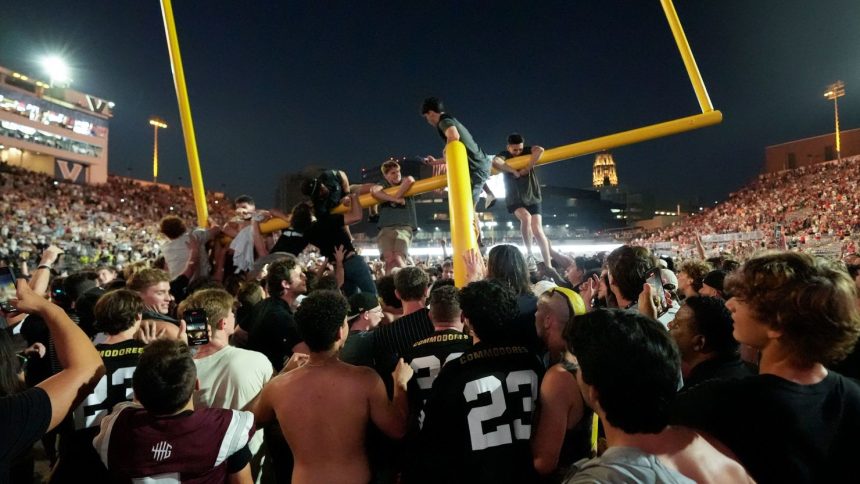 Vanderbilt fans tear down the goal post the after team's 40-35 win over No. 1 Alabama, Saturday, October 5, 2024, in Nashville, Tennessee.