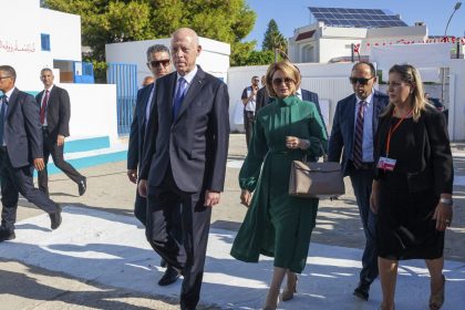 The Tunisian president and candidate for re-election, Kais Saied, front, and his wife Ichraf Chebil Saied arrive at a polling station to cast their votes in the capital Tunis on Oct. 6, 2024.