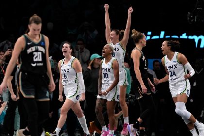 Minnesota Lynx players celebrate after defeating the New York Liberty in overtime in Game 1 of the WNBA Finals.