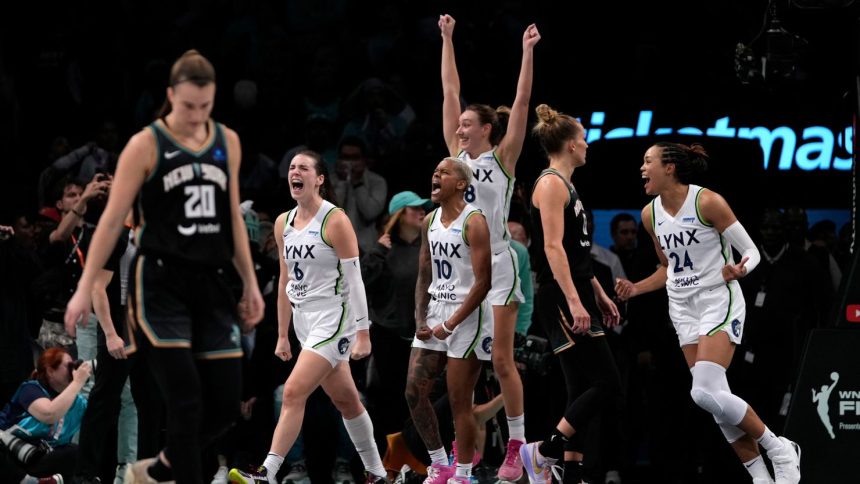 Minnesota Lynx players celebrate after defeating the New York Liberty in overtime in Game 1 of the WNBA Finals.