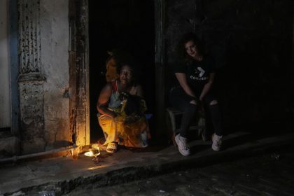 Residents pass the time during a blackout following the failure of a major power plant in Havana, Cuba on Saturday, Oct. 19, 2024.