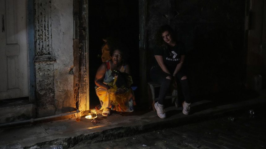 Residents pass the time during a blackout following the failure of a major power plant in Havana, Cuba on Saturday, Oct. 19, 2024.