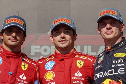 Ferrari driver Carlos Sainz (left) stands with race winner and teammate Charles Leclerc (middle) and Red Bull driver Max Verstappen (right), who placed third in the US Grand Prix.