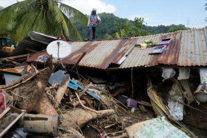 Marcelino Aringo stands on top of a damaged house after a landslide triggered by Tropical Storm Trami recently struck Talisay, Batangas province, Philippines, on Oct. 26, 2024.