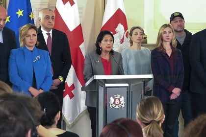 Georgian President Salome Zourabichvili, center, surrounded by opposition leaders, speaks to the media after the parliamentary election in Tbilisi, Georgia, on Oct. 27, 2024.