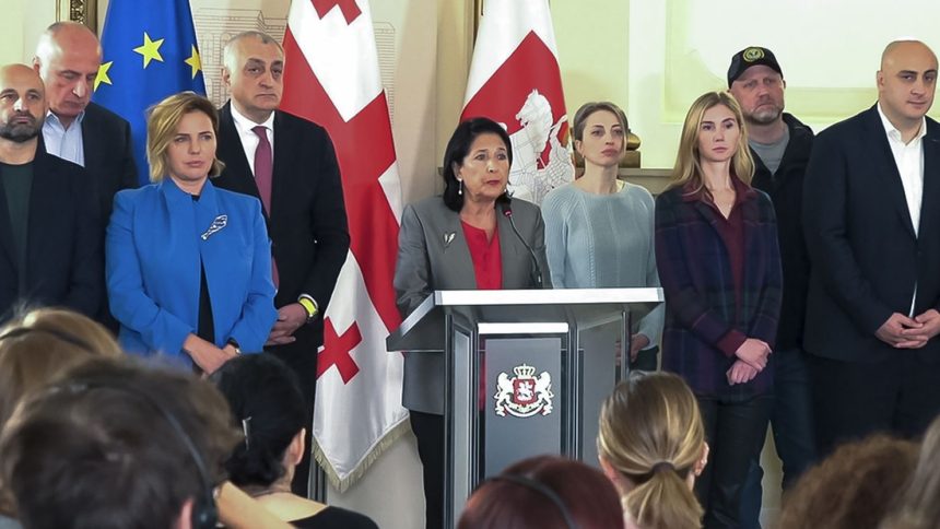 Georgian President Salome Zourabichvili, center, surrounded by opposition leaders, speaks to the media after the parliamentary election in Tbilisi, Georgia, on Oct. 27, 2024.