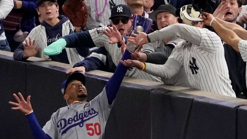 Two New York Yankees fans were ejected from Game 4 of the World Series after ripping the ball from Los Angeles Dodgers star Mookie Betts’ glove.