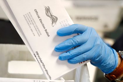 In this May 2020 photo, a worker processes mail-in ballots at the Bucks County Board of Elections office prior to the primary election in Doylestown, Pennsylvania.