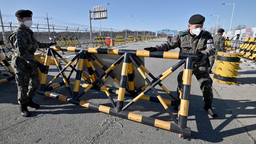 South Korean soldiers set a barricade at a checkpoint on the Tongil bridge, near the Demilitarized Zone (DMZ) dividing the two Koreas in Paju on December 15, 2020.