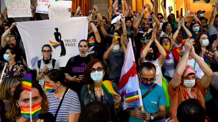 Participants hold rainbow flags during a rally in support of those who were injured when a pride march was disrupted by members of violent groups, in Tbilisi, Georgia on July 6, 2021.