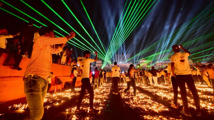 People in the Indian city of Ayodhya watch a laser show on the eve of Diwali in 2021.