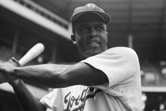 Jackie Robinson, the first Black player in Major League Baseball, ahead of a game against the Pittsburgh Pirates on August 28, 1949.