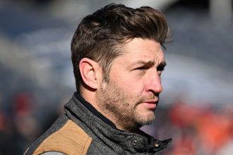 Former NFL quarterback Jay Cutler watches a Chicago Bears game in 2022.