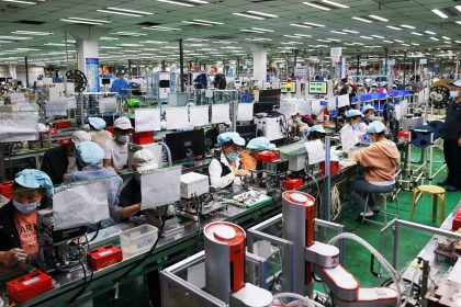 Employees work at a Foxconn factory in Henan province's Zhengzhou in 2021.