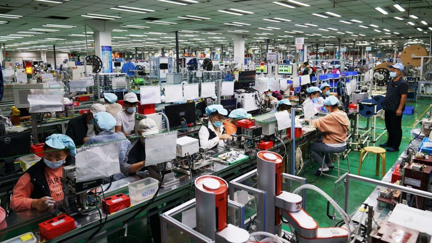 Employees work at a Foxconn factory in Henan province's Zhengzhou in 2021.