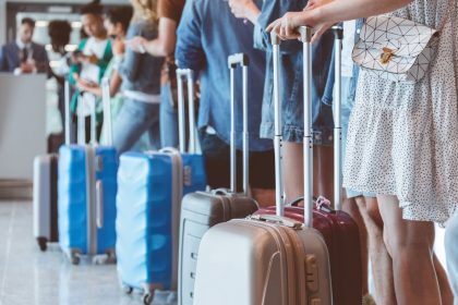 Flyers wait in line for boarding. At select airports, people who attempt to board too early could be beeped.