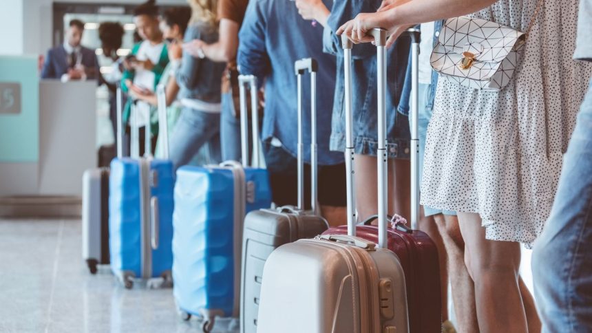 Flyers wait in line for boarding. At select airports, people who attempt to board too early could be beeped.