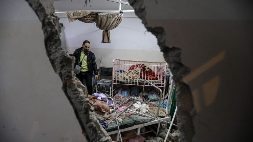 People inspect the damage caused by an artillery shell that hit the maternity hospital inside the Nasser Medical Complex, in Khan Younis, Gaza on December 17.