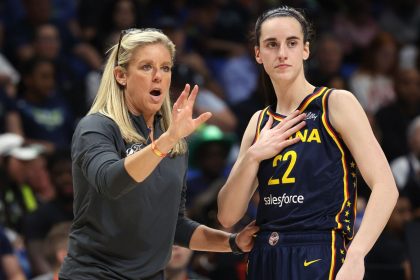 Indiana Fever guard Caitlin Clark talking to head coach Christie Sides during a preseason game.