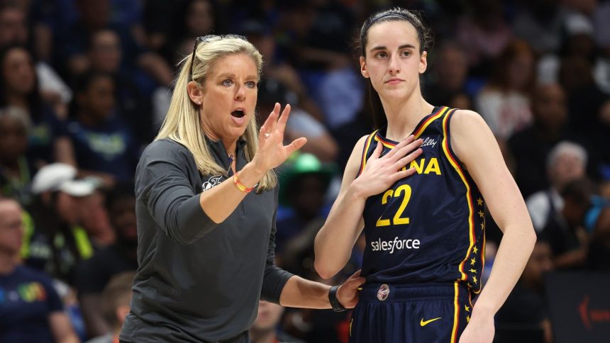 Indiana Fever guard Caitlin Clark talking to head coach Christie Sides during a preseason game.