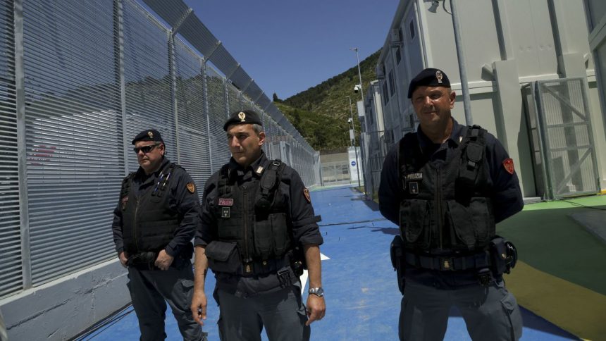 Italian police officers stand guard inside a recently build Italian-run migrant centre at the port of Shengjin, some 60 kilometers northwest of Tirana, on June 5, 2024.