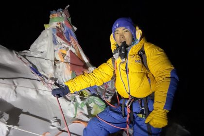 This handout photograph taken on May 24, 2024, and released by 14 Peaks Expedition shows Nepali mountaineer Nima Rinji Sherpa at the summit of Mount Everest. At just 18 years old, Nepali mountaineer Nima Rinji Sherpa is on the brink of a remarkable achievement. With 13 of the world's highest peaks already behind him, he is now just one summit away from becoming the youngest person ever to conquer all 14 mountains towering above 8,000 meters (26,247 feet). His final challenge, Shishapangma in Tibet, awaits him next month -- if China issues a permit. (Photo by 14 Peaks Expedition / AFP) / RESTRICTED TO EDITORIAL USE - MANDATORY CREDIT "AFP PHOTO / 14 Peaks Expedition " - NO MARKETING NO ADVERTISING CAMPAIGNS - DISTRIBUTED AS A SERVICE TO CLIENTS (Photo by -/14 Peaks Expedition/AFP via Getty Images)