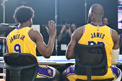 New Los Angeles Lakers guard Bronny James (No. 9) sits next to his dad LeBron James at the Lakers media day at UCLA Health Training Center in El Segundo, California.