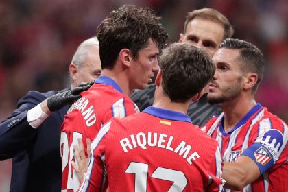 Atlético Madrid defender Robin Le Normand (No. 24) stands after inadvertently clashing heads with Aurelien Tchouameni of Real Madrid