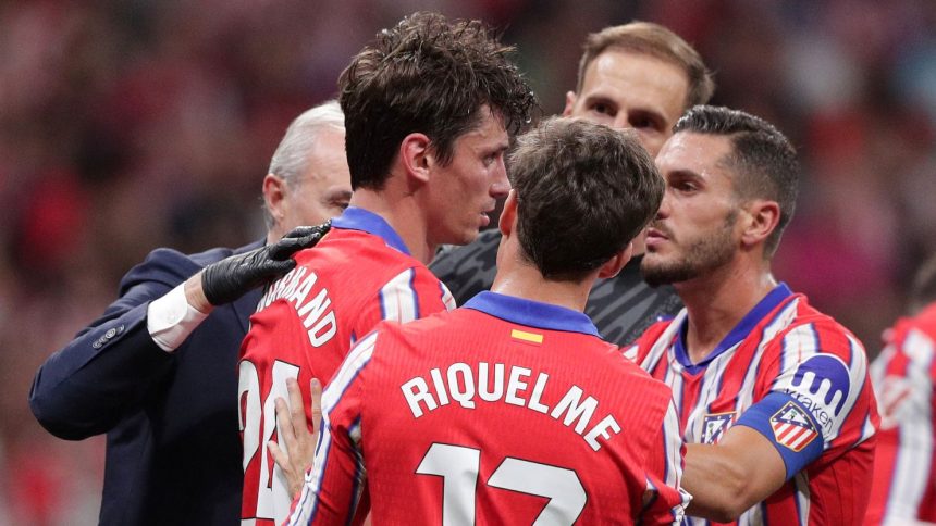 Atlético Madrid defender Robin Le Normand (No. 24) stands after inadvertently clashing heads with Aurelien Tchouameni of Real Madrid